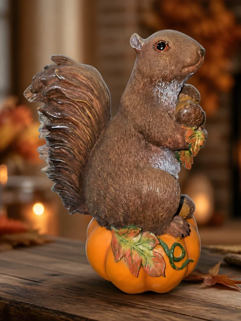 vintage resin autumn squirrel figurine perched atop a pumpkin Holdinging Nuts